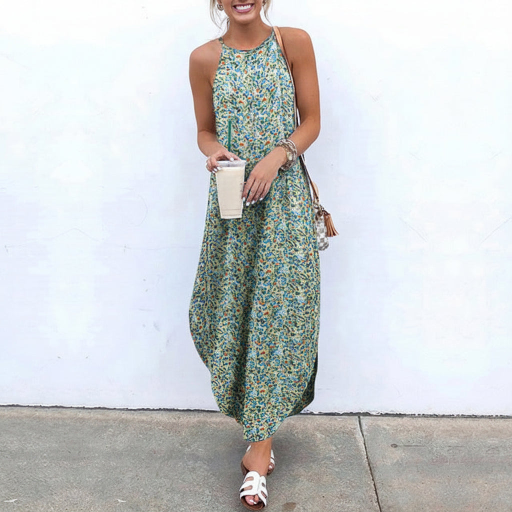 Woman wearing a floral dress against a white wall